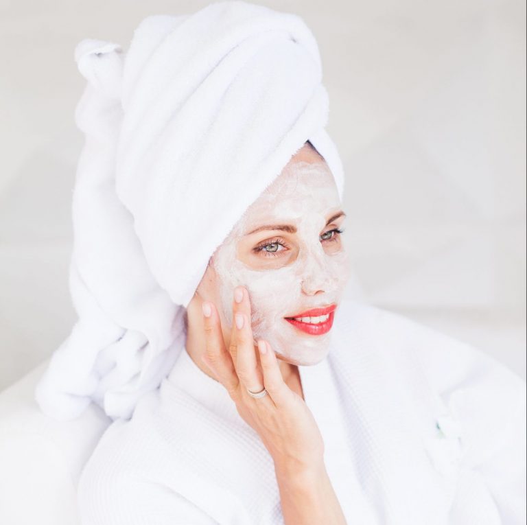Woman relaxing with an exfoliating facial mask.